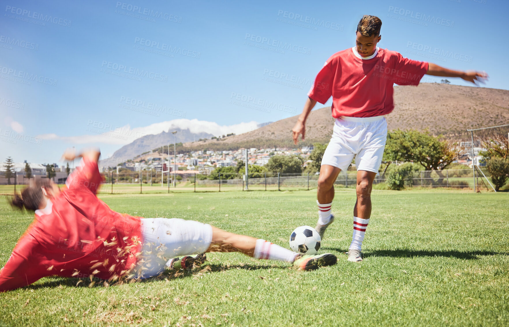 Buy stock photo Men, soccer and slide tackle in sports fitness, training and exercise on the field outdoors. Athletic man tackling football player in sport for control, possession or defense in game or match outside