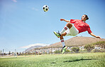 Fitness, soccer and athlete scoring a goal at a game or sports training at an outdoor field. Skill, jump and man football player practicing a kick and score with ball exercise on pitch for motivation