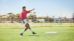 Soccer, sports and fitness with a man athlete playing a game or match on a grass pitch outdoor in summer. Football, training and exercise with a male soccer player at practice for a competitive sport