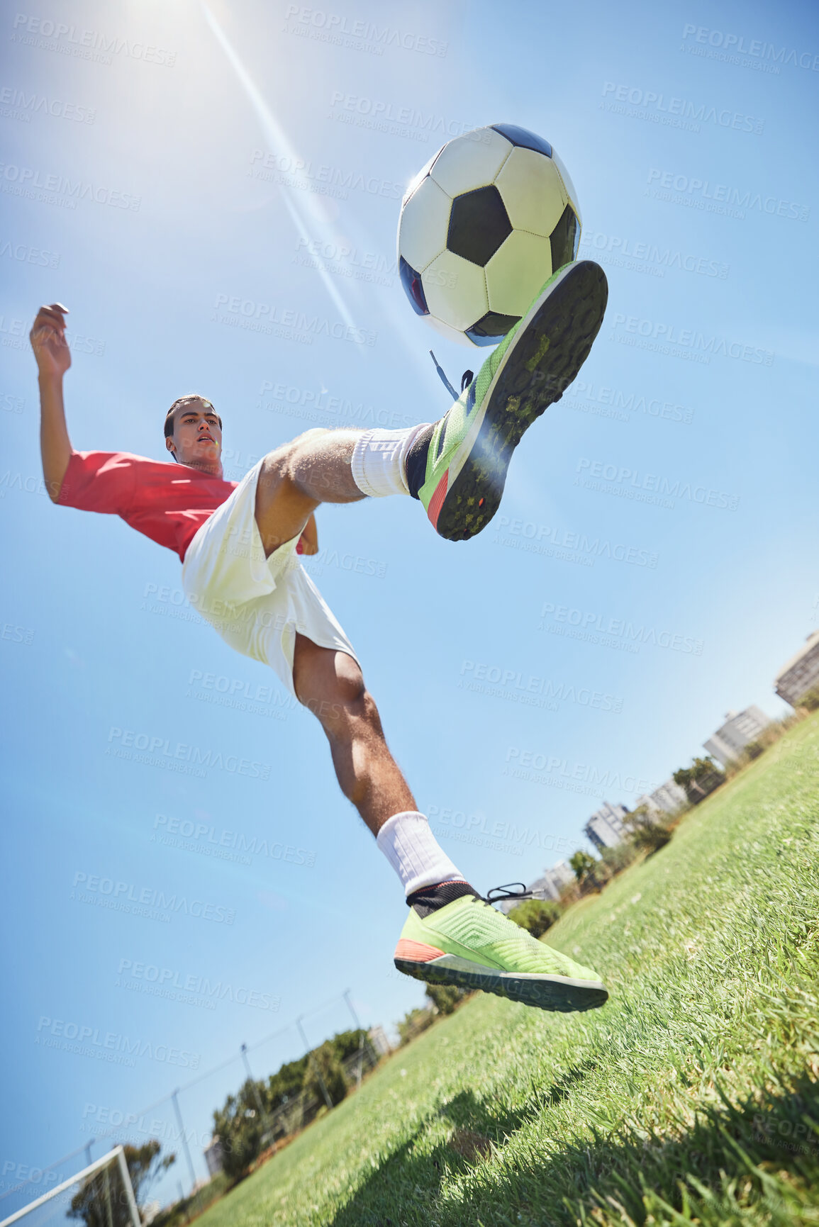Buy stock photo Football, fitness and soccer player training with a juggling exercise on soccer field, grass or football stadium. Sports, jumping and below view of a healthy athlete with skills and creative talent