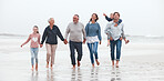 Family, beach and children with grandparents, parents and kids walking in the water on the sand in a summer holiday. Travel, love and vacation with a girl, boy and relatives taking a walk by the sea