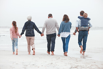 Buy stock photo Holding hands, walking and big family on the beach for exercise while on summer vacation. Grandparents, parents and children on outdoor walk in nature by ocean while on holiday, adventure or journey.