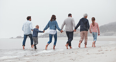 Buy stock photo Love, walking and family holding hands on the beach, bond or enjoy fun quality time together on vacation back view. Support trust, peace and big family travel on Canada adventure holiday for freedom