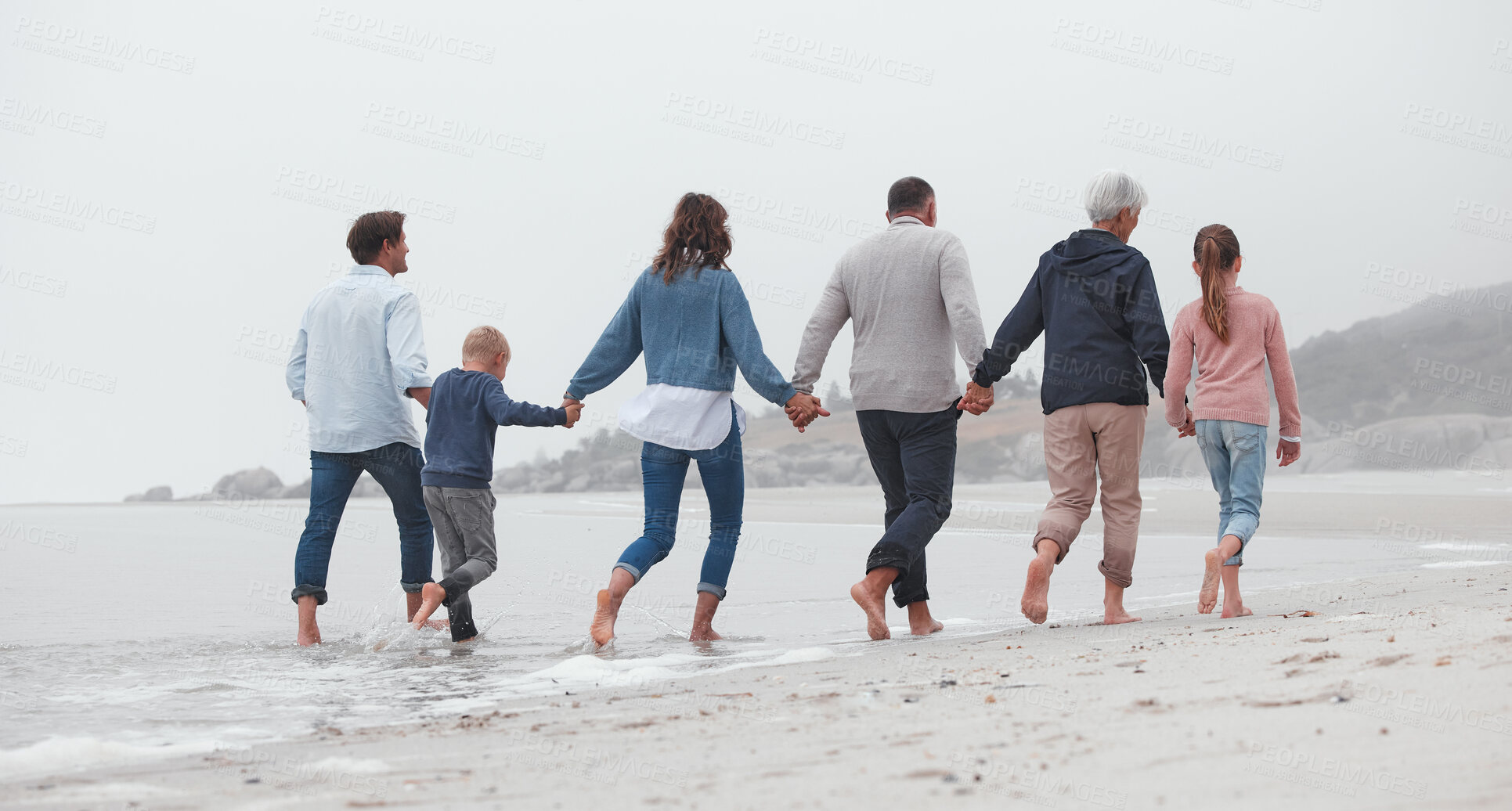 Buy stock photo Love, walking and family holding hands on the beach, bond or enjoy fun quality time together on vacation back view. Support trust, peace and big family travel on Canada adventure holiday for freedom