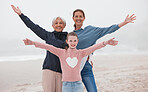 Family, love and beach with a girl, mother and grandmother on the sand by the sea or ocean during a vacation together. Travel, love and nature with a senior woman, daughter and grandchild on holiday