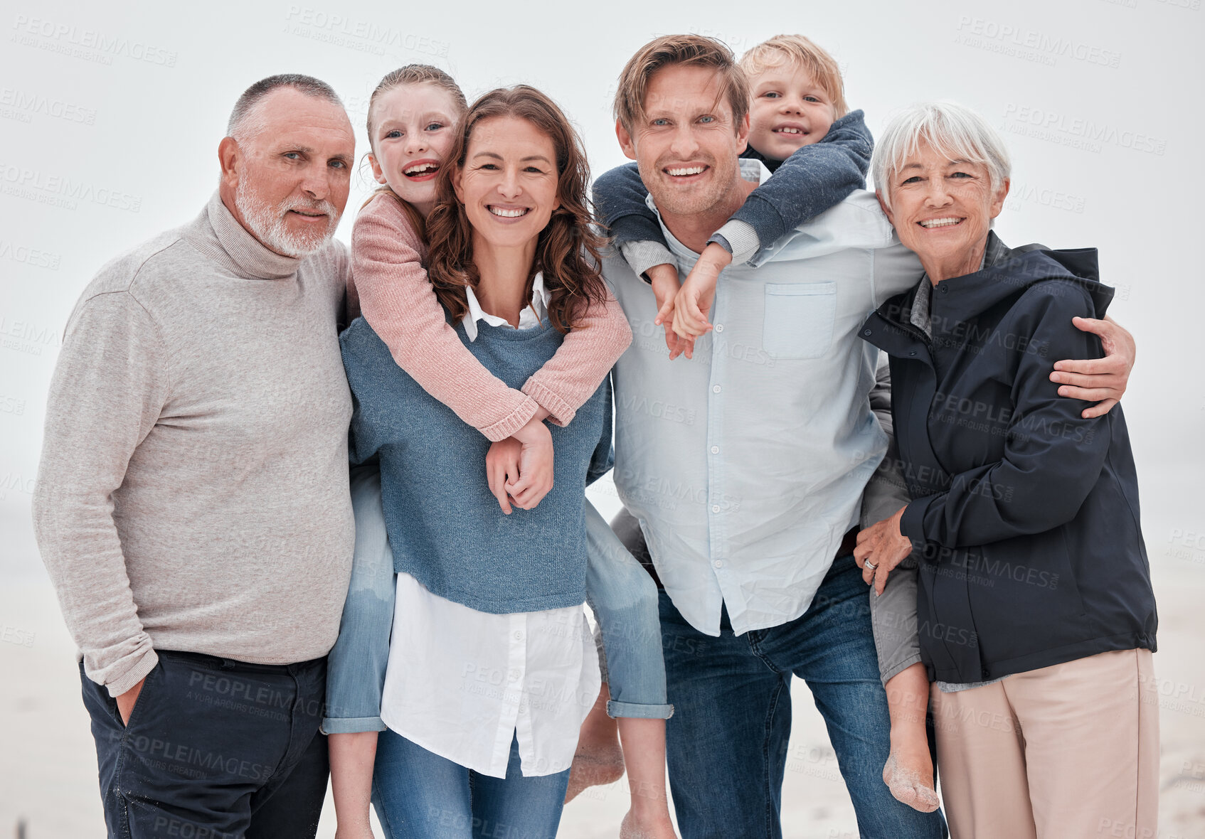 Buy stock photo Big family, happy and outdoor of a hug with parents, grandparents and children with happiness. Portrait of mother, father and kids with care, love and a smile together with senior people hug