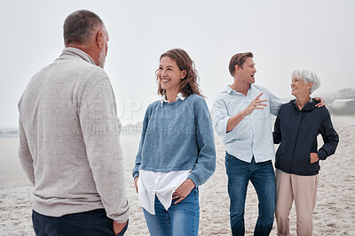 Buy stock photo Family bonding, beach and outdoor conversation of people happy spending time together. Communication of a woman, man and elderly parents on ocean sand on a cloudy day on vacation with happiness