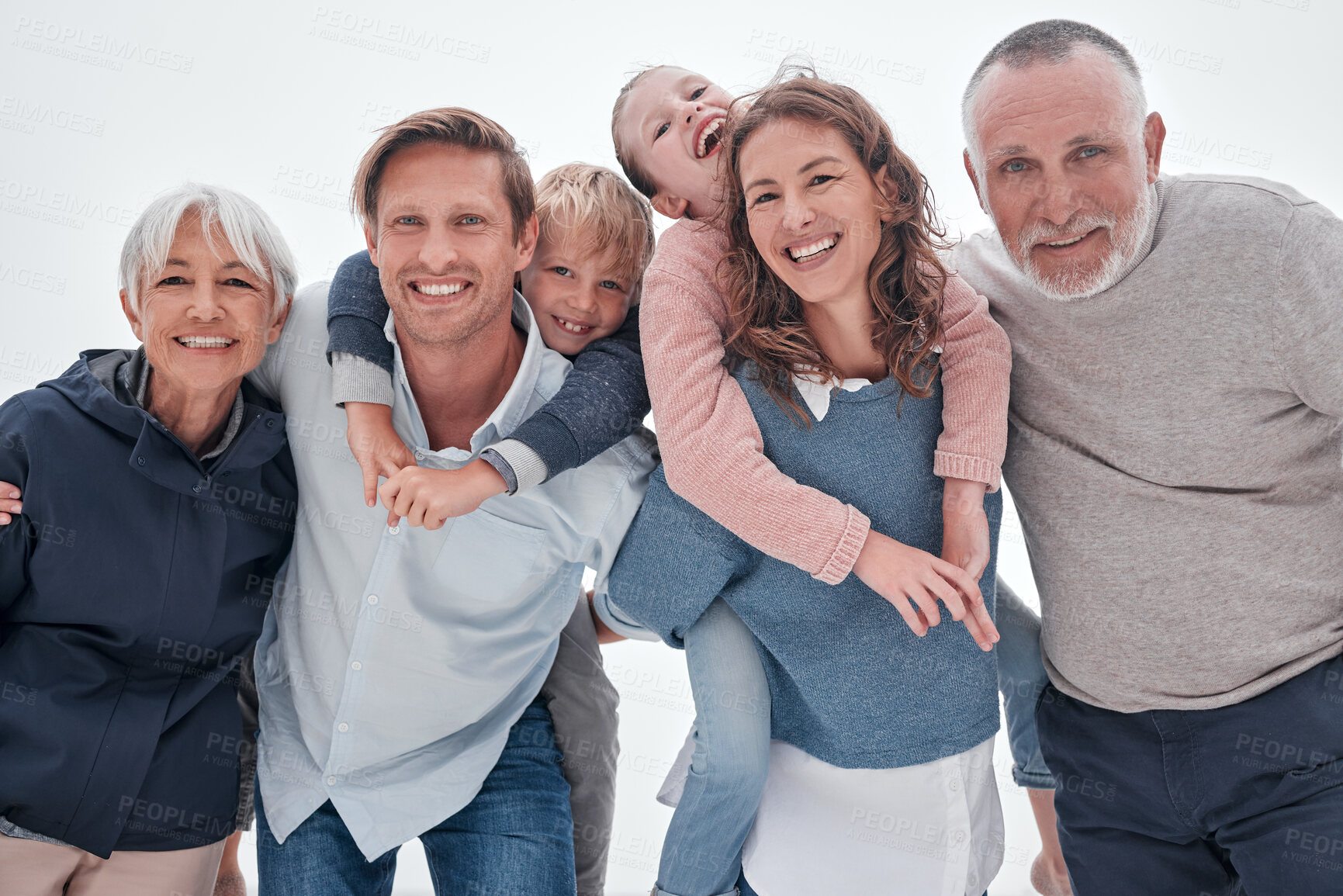 Buy stock photo Happy big family, portrait and piggy back on holiday, vacation or trip against cloudy sky. Love, care and man, woman and children with grandparents bonding outdoors together in misty winter weather.
