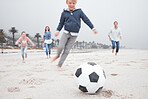 Family, soccer and beach playing on sand together for fun bonding time for sports and exercise in nature. Happy children and parents in playful fitness for football game on a sandy ocean shore