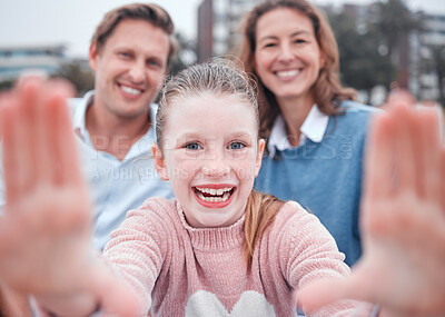 Buy stock photo Girl, hand frame and family for selfie with smile, portrait or happy in city, metro or town at park, comic or bonding. Mother, father or kid with parents, laugh or funny in photo, outdoor or together