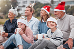 Happy, big family and relax for Christmas holiday, bonding and quality time together in the outdoors. Parents, grandparents and kids with drink in family celebration for December, festive or new year