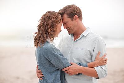 Buy stock photo Travel, beach and tourism vacation with happy couple sharing hug, love and smile  while on holiday by the seaside. French man and woman enjoying honeymoon with romance at misty outdoor destination
