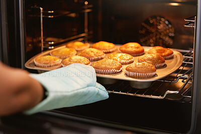 Buy stock photo Hand, oven and muffins in baking, food or cooking sweet delicious cakes on a tray at home in the kitchen. Hands of baker taking hot muffin baked meal, treat or delight in pastry making at the house