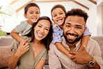 Black family, happy and bonding of mother, father and children together on a house lounge sofa. Portrait of parents and kids smile on a living room lounge couch with happiness spending quality time
