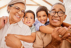 Grandparents, hug and children together at a house with happiness, family love and child care. Portrait of happy elderly people with kids smiling, bonding and spending quality time at a family home