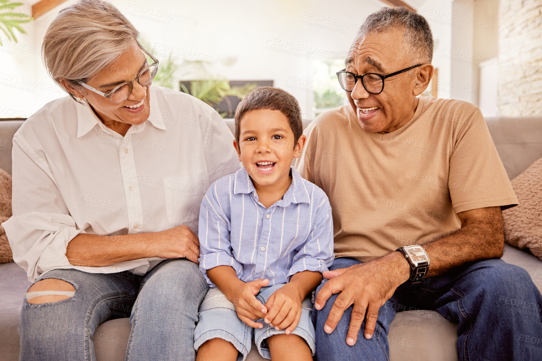 Buy stock photo Relax, happy and grandparents with child on sofa together for smile, love and retirement. Peace, youth and portrait of old man and woman with kid in living room in family home for care, hug and calm