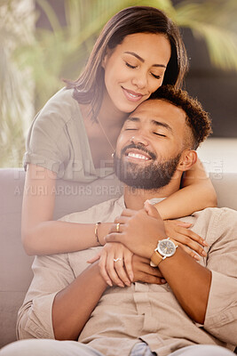 Buy stock photo Couple, man and black woman on sofa for hug, love and care in living room to relax while happy. Black man, woman and marriage for romance, embrace and smile together on couch in lounge with happiness