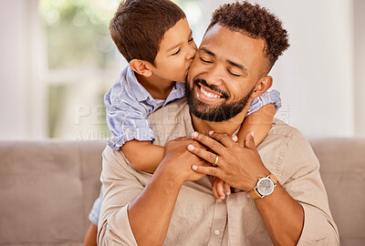 Buy stock photo Kiss, father and child with hug on the sofa of their living room in their house. Happy, smile and young father hugging his  kid with affection, care and love on the couch of their home together