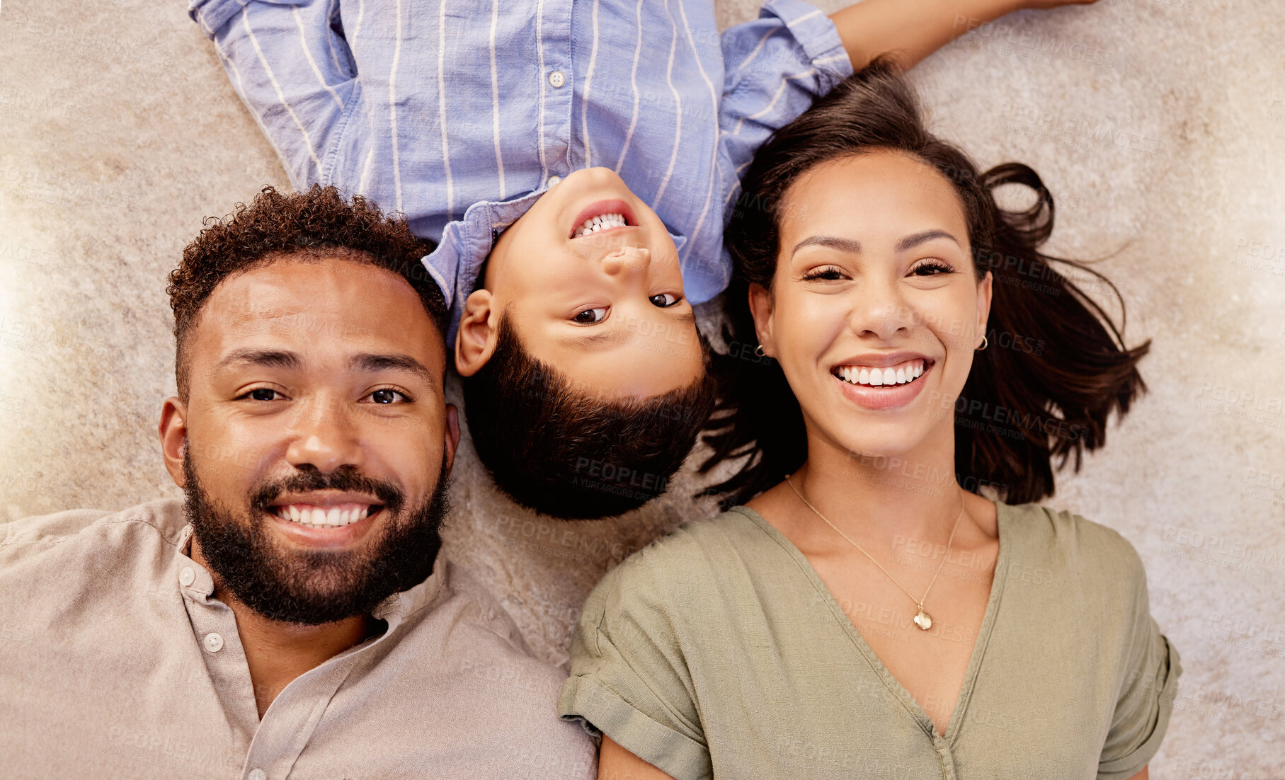 Buy stock photo Father, mother and child smile on the carpet together bonding and spending quality time at home. Portrait of a happy dad, family and mother with a kid feeling relax top view with love and care