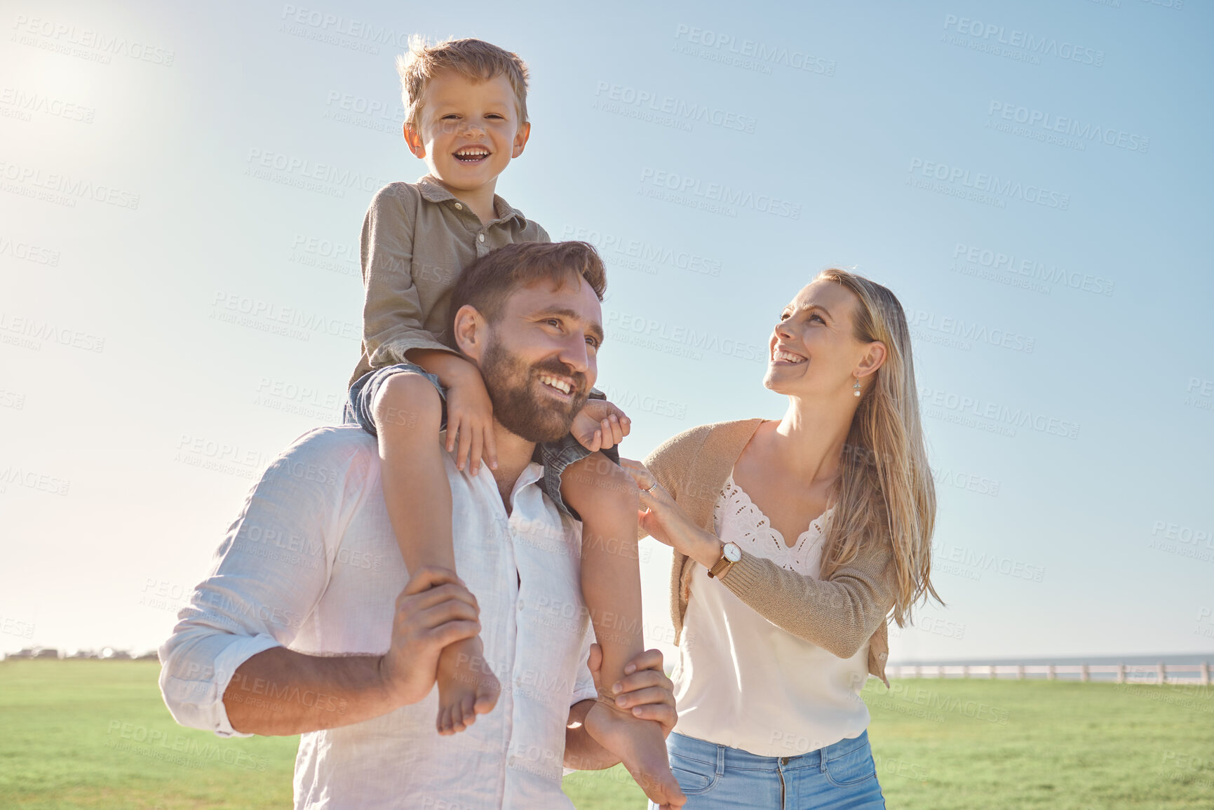 Buy stock photo Walk, smile and child with parents in a park for freedom, peace and happiness during summer. Portrait of a happy, free and relax kid with his mother and father walking in a nature field with love