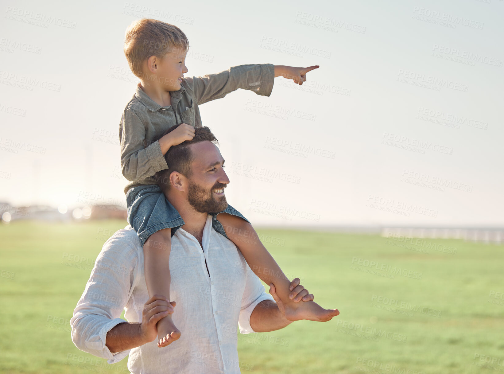 Buy stock photo Father, kid and bonding outdoor in nature looking at a view with happiness and family care. Happy dad and kid together with a smile enjoying a summer day and vacation on a grass field with a child