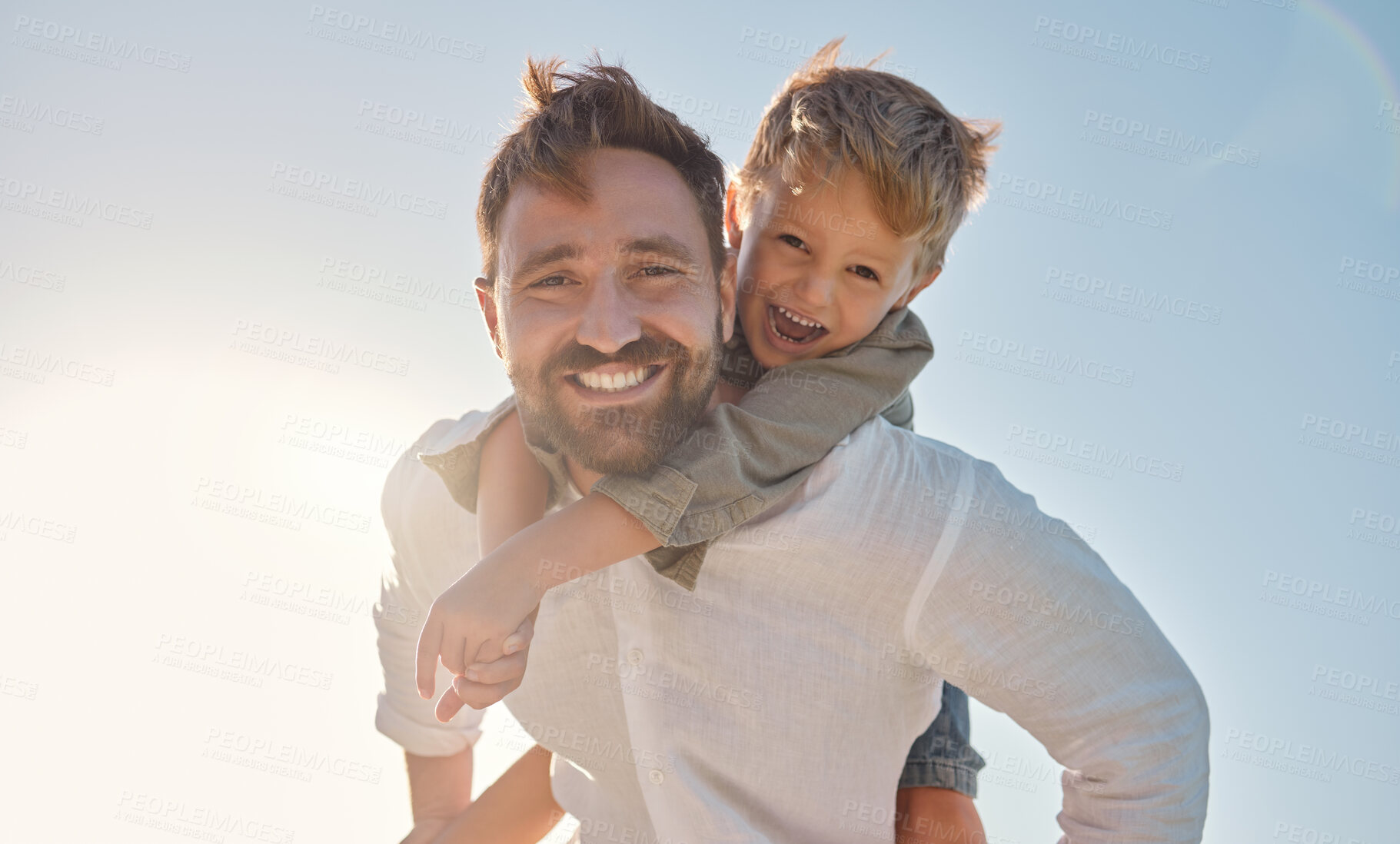 Buy stock photo Family, portrait and father and son relax against a blue sky background, playing and having fun outdoors. Happy family, travel and child embracing dad in nature, laughing and enjoying summer together