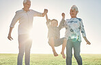 Family, holding hands and grandparents with boy in park, nature or outdoors. Love, support and happy man and woman lift child, kid and having fun time, care or bonding with smile together in sunshine