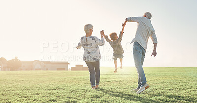Buy stock photo Love, grandparents and child being playful, happy and bonding on grass, outdoor and together. Grandmother, grandfather and kid enjoy summer holidays, adventure or travel for walking or holding hands