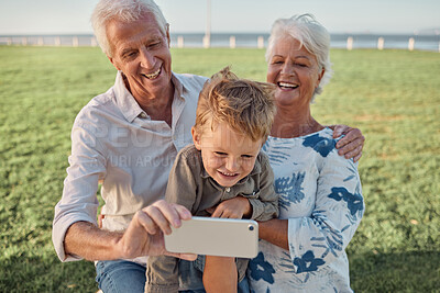 Buy stock photo Happy family, grandparents and child take a selfie in nature with a phone camera for bonding memories outdoors. Smile, old man and elderly woman laughing with an excited young kid on holiday vacation