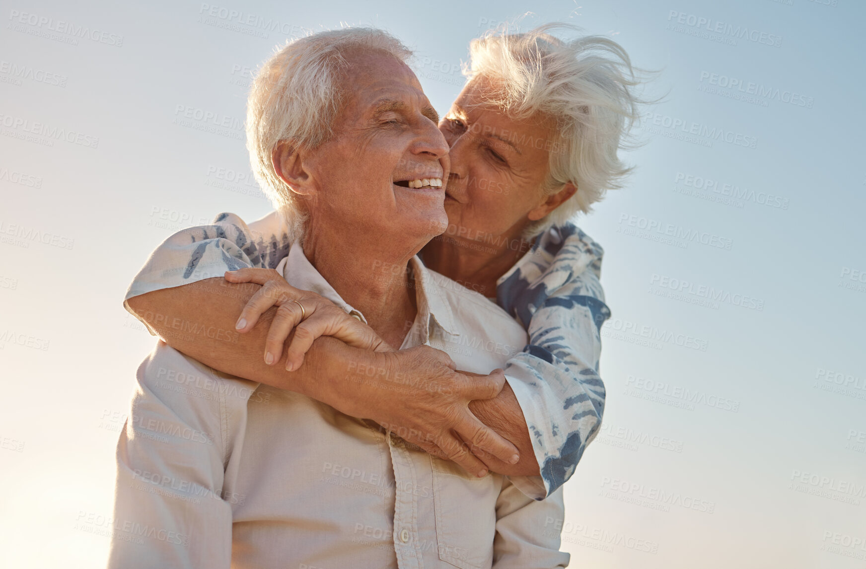 Buy stock photo Kiss, hug and senior couple with love, care and happiness in their marriage together in nature. Happy, relax and smile from an elderly man and woman hugging and kissing for gratitude and commitment