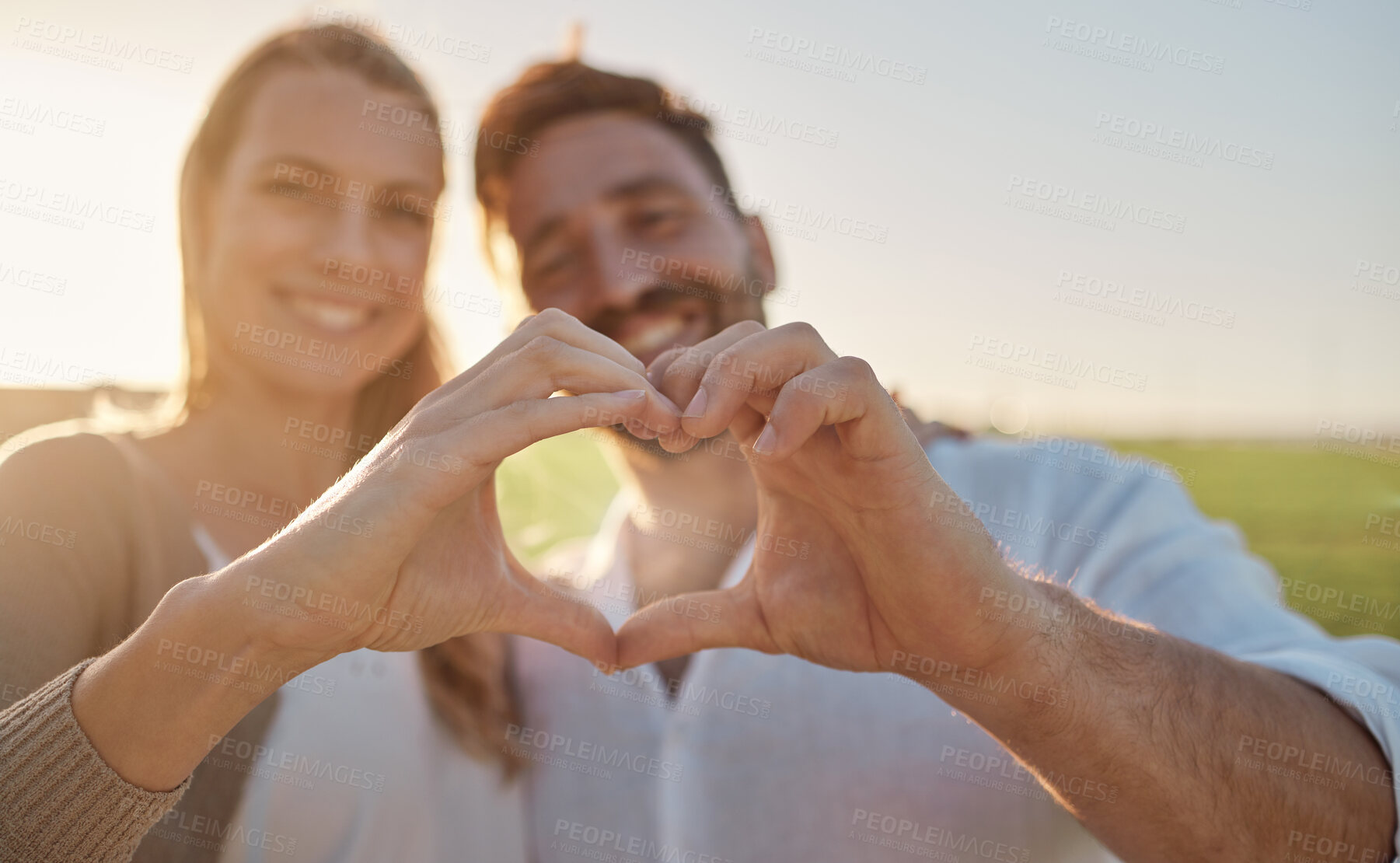 Buy stock photo Heart, hands and couple with smile in a park for love, care and adventure in their marriage together in France. Happy, young and man and woman on date in nature with a loving gesture with hands