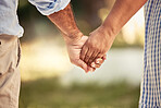 Old couple, love and holding hands for support in nature, park or outdoors walk. Retirement, romance and elderly, man and woman bonding, affection and enjoying time together outside in the morning.