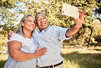 Love, phone and old couple taking a selfie in nature on a happy retirement holiday vacation in summer in Brazil. Smile, freedom and senior woman enjoys taking pictures or photo outdoors with partner 