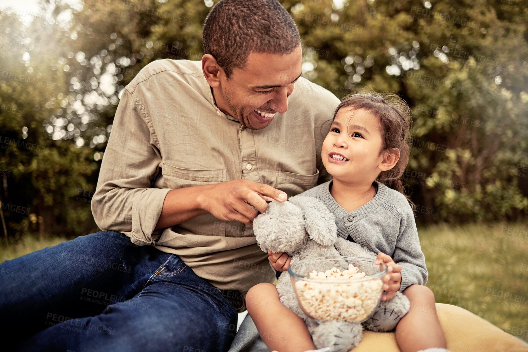 Buy stock photo Father, girl and popcorn eating of a happy child and parent outdoor laughing with a smile. Dad, happiness and kid with food hug together with bonding, quality time and nature experience having fun