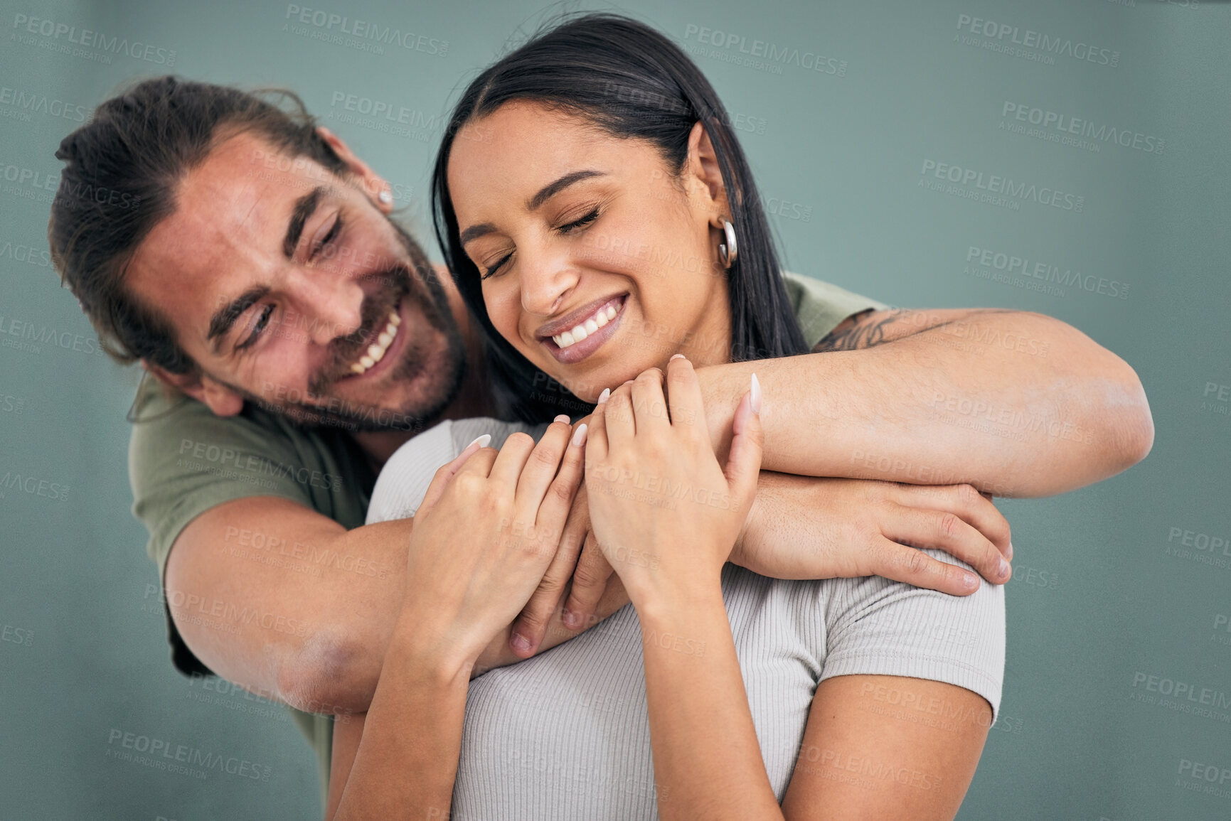 Buy stock photo Love, hug and support of a couple in a home with smile, care and affection. Trust, help and embrace of marriage or young interracial people, comforting partner together in their house with happiness
