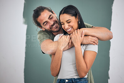 Buy stock photo Happy, couple and hug for love, home improvement and smile against a painted wall background. Man and woman smiling for creative interior design in relationship, painting or house renovation together