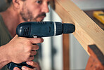 Man, drill wood and build for home interior or wardrobe renovation. Professional carpenter, house construction improvement and focused handyman maintenance worker drilling hole in wooden bar 
