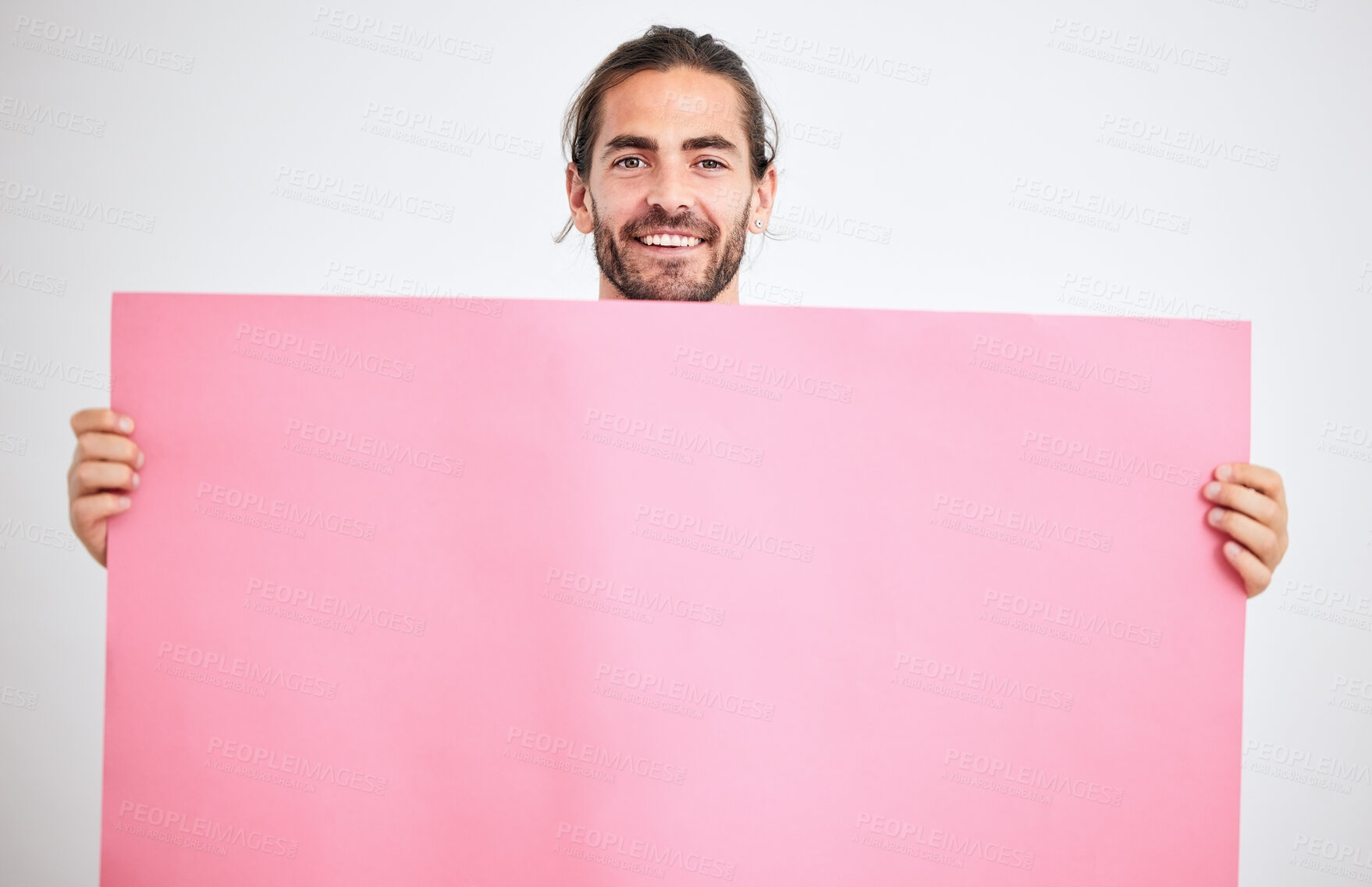 Buy stock photo Portrait of man with poster, banner or paper sheet for marketing, advertising or product placement mockup. Happy, smile and person holding a pink mock up billboard for promotion on white background