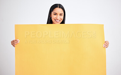 Buy stock photo Woman with yellow mockup poster for advertising, marketing and product placement on blank cardboard. Happy, smile and a model in studio with sign board in hands for text, brand or logo advertisement.