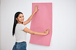 Woman, wall and wallpaper with smile in house for color, change or texture in interior, home or room with happiness. Happy, creative and designer with paper, pink and design for renovation at work