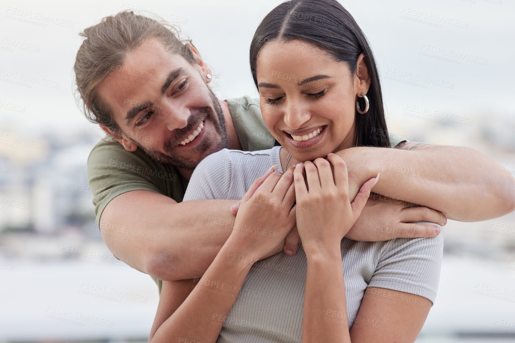 Buy stock photo Care, interracial and hug for love in couple relationship with happy woman holding hands of man. Indian girlfriend of caucasian partner enjoying bonding embrace for affection together in Canada.

