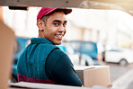 Logistics, smile and man with box at van looking back, trust and success in courier service for ecommerce business. Supply chain, cargo and stock distribution, delivery driver at truck with package.