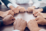 Teamwork, circle and business people hands in fist on the table in meeting. Diversity, support and collaboration in office with team connect in workplace for motivation, inspiration and team building
