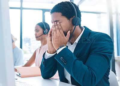 Buy stock photo Stress, customer support and call center employee with a headache in a workplace with headset. Customer service, crm and bored African ecommerce sales man with burnout working in telemarketing office