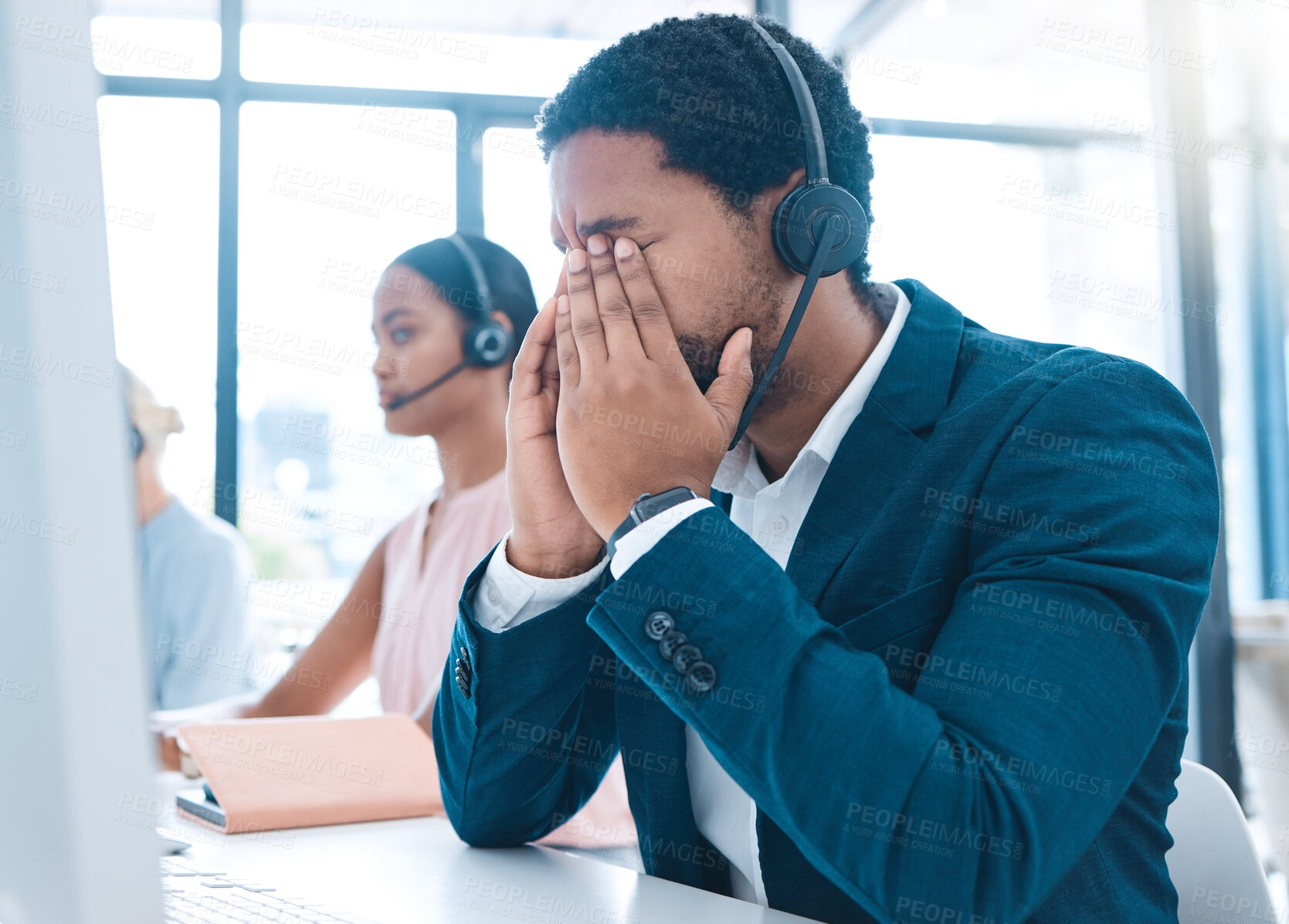 Buy stock photo Stress, customer support and call center employee with a headache in a workplace with headset. Customer service, crm and bored African ecommerce sales man with burnout working in telemarketing office