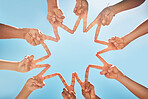 Group, hands and fingers with star for peace, solidarity and blue sky in sunshine on vacation. Friends, family and fun at work in holiday, summer or bonding with sign, hand signal and together in sun