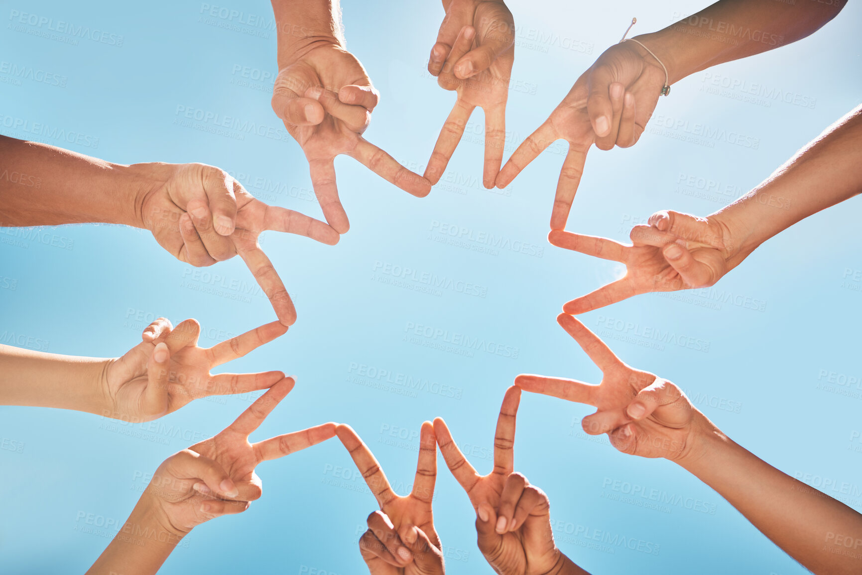 Buy stock photo Group, hands and fingers with star for peace, solidarity and blue sky in sunshine on vacation. Friends, family and fun for community, support and summer for bonding with sign, connected and together