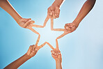 Hands, star and teamwork with friends in a huddle on a clear blue sky background from below. Trust, support and community with a group of people making a hand sign shape outdoor together in the day