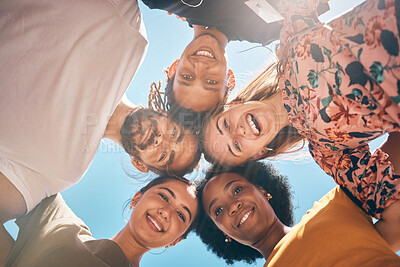 Buy stock photo Friends, diversity and huddle with a man and woman group standing outdoor together on a blue sky in summer. Travel, smile and community with male and female people outside with a smile from below