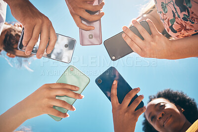 Buy stock photo Phone circle, hands of people and low angle, communication or text. Blue sky, mobile and friends on social media, online group chat or wifi, sharing 5g data and surfing internet, web or online.
